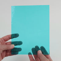 Video of the Aqua Transparent glass plate in transparent blue, 15x19cm, held up and tilted to show its pattern and transparency