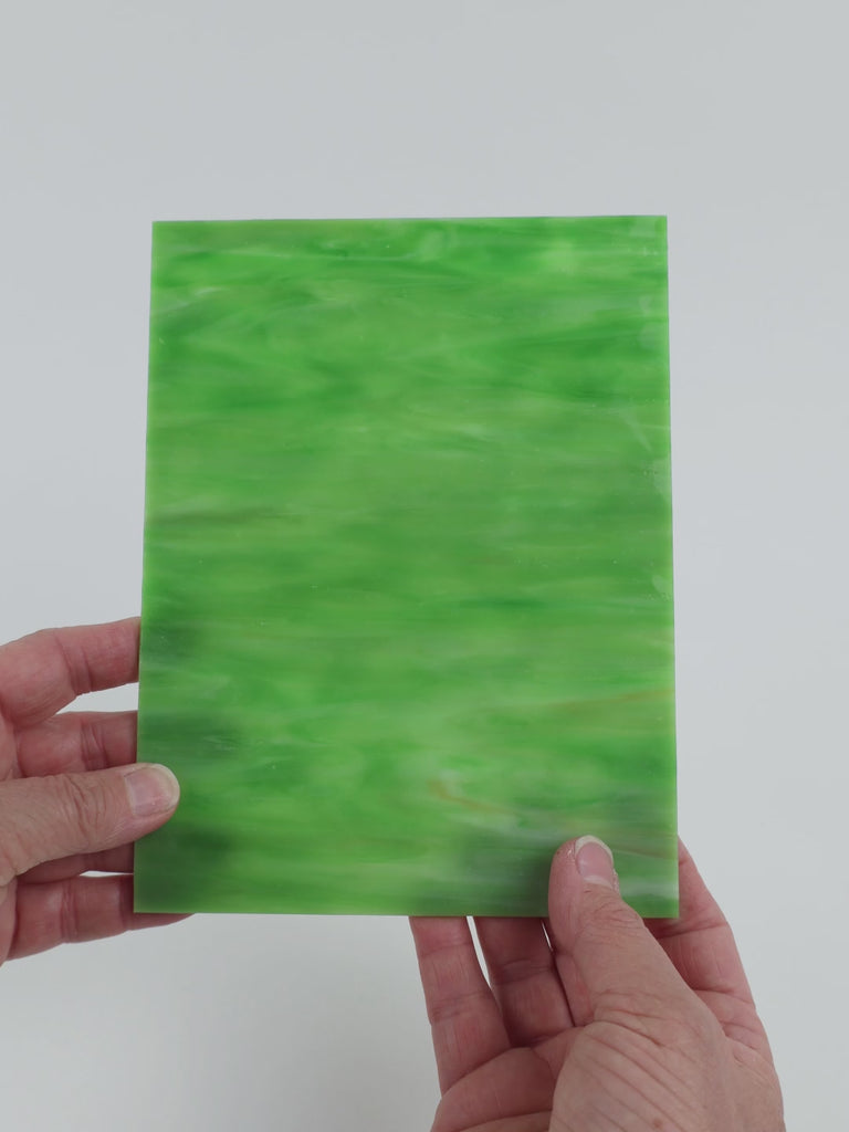 Video of the Green White glass plate in ripple translucent green, 15x19cm, held up and tilted to show its pattern and transparency