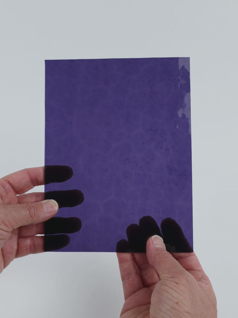 Video of the Purple Textured glass plate in hammered transparent purple, 15x19cm, held up and tilted to show its pattern and transparency