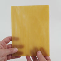 Video of the pecan glass plate in amber translucent, 15x19cm, held up and tilted to show its pattern and transparency