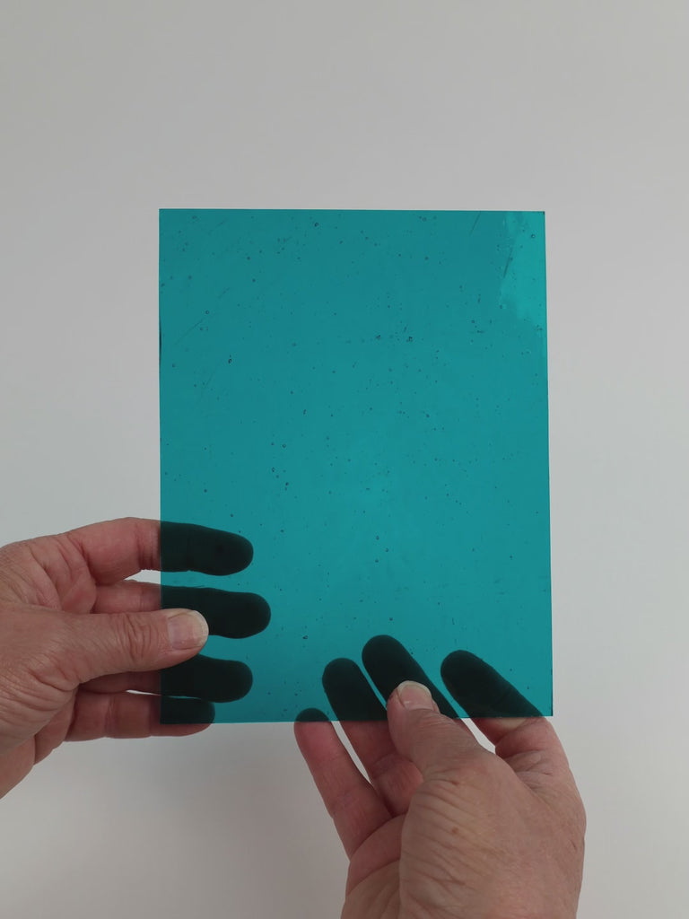 Video of the Steel Blue glass plate in transparent teal, 15x19cm, held up and tilted to show its pattern and transparency