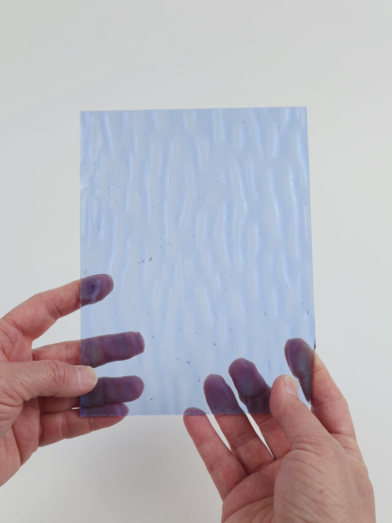 Video of the Pale Blue glass plate in ripple transparent blue, 15x19cm, held up and tilted to show its pattern and transparency