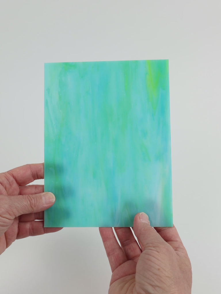 Video of the Teal Lime Opal glass plate in translucent teal, 15x19cm, held up and tilted to show its pattern and transparency