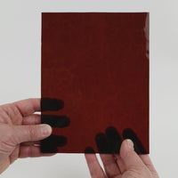 Video of the Brown Hammered glass plate in transparant brown, 15x19cm, held up and tilted to show its pattern and transparency