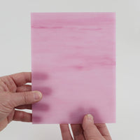 Video of the Pink Streaky glass plate in translucent pink, 15x19cm, held up and tilted to show its pattern and transparency