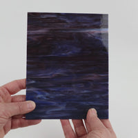 Video of the Northern Lights glass plate in translucent blue, 15x19cm, held up and tilted to show its pattern and transparency