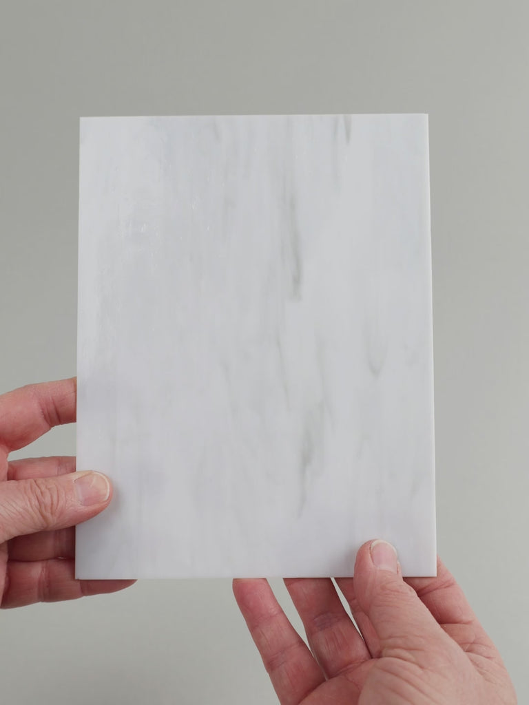 Video of the pale grey marble glass plate in grey marbled translucent, 15x19cm, held up and tilted to show its pattern and transparency
