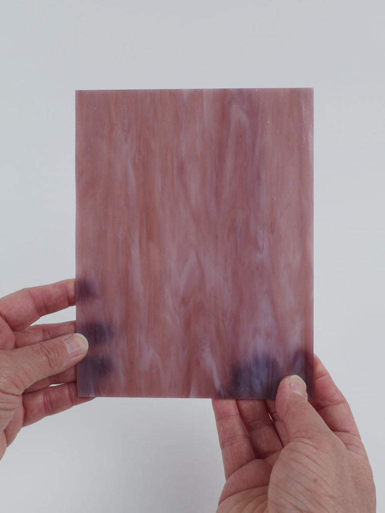 Video of the Pale Violet Streaky glass plate in translucent purple, 15x19cm, held up and tilted to show its pattern and transparency