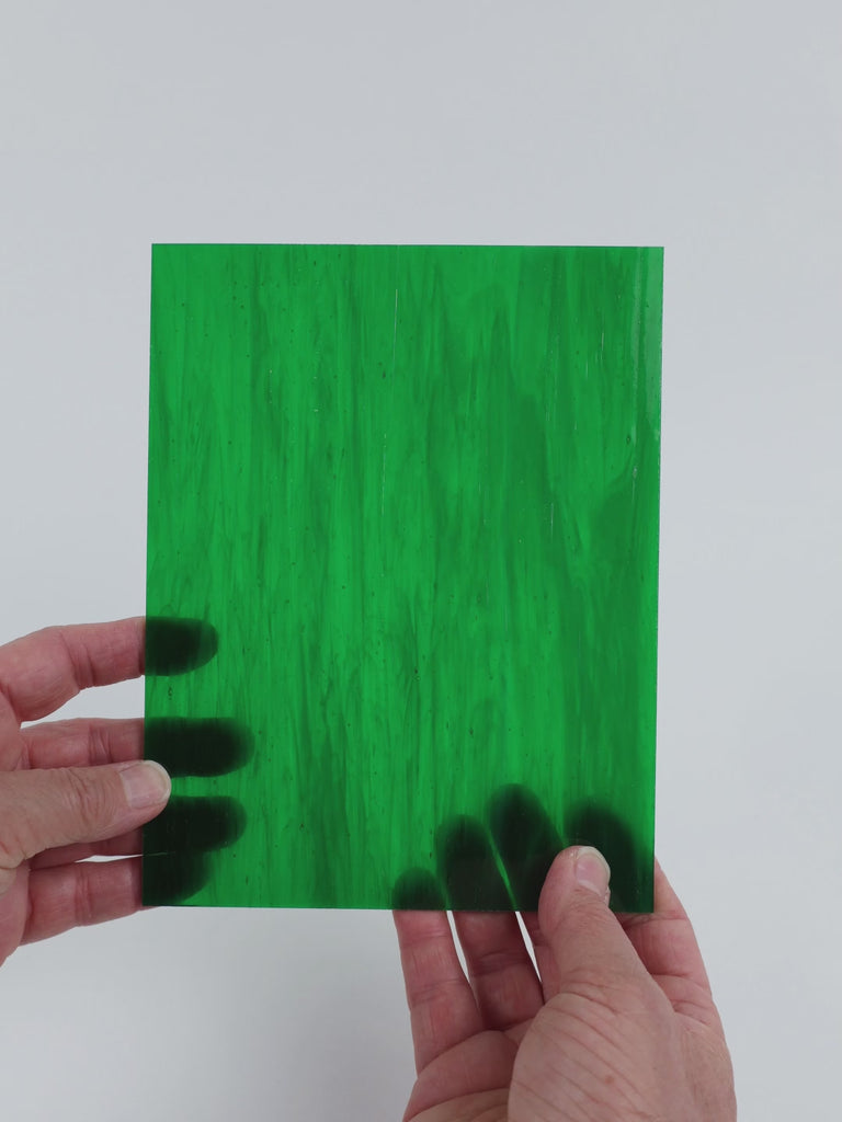 Video of the Secret Garden glass plate in translucent green, 15x19cm, held up and tilted to show its pattern and transparency