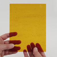 Video of the Golde Syrupglass plate in transparant amber, 15x19cm, held up and tilted to show its pattern and transparency