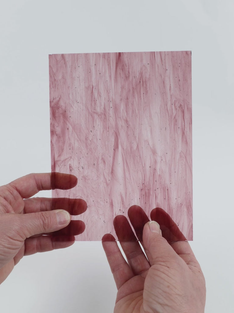 Video of the Violet Wispy glass plate in transparent purple, 15x19cm, held up and tilted to show its pattern and transparency