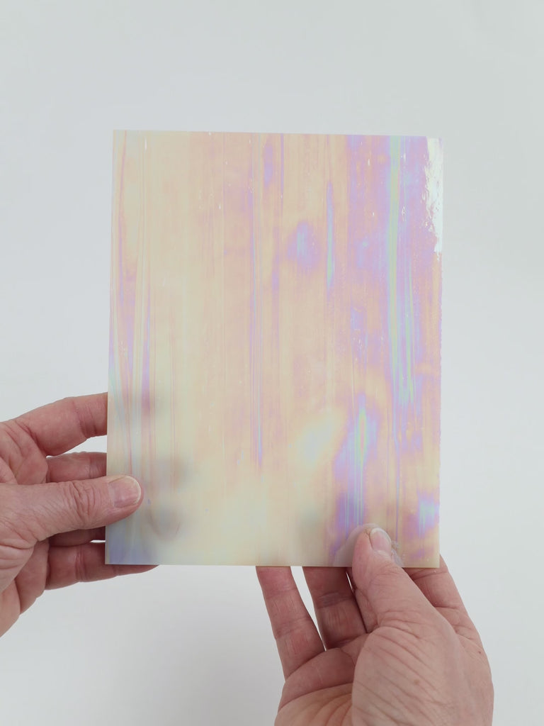 Video of the Blush Gentle Waves glass plate in iridescent translucent pink, 15x19cm, held up and tilted to show its pattern and transparency