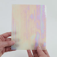Video of the Blush Gentle Waves glass plate in iridescent translucent pink, 15x19cm, held up and tilted to show its pattern and transparency