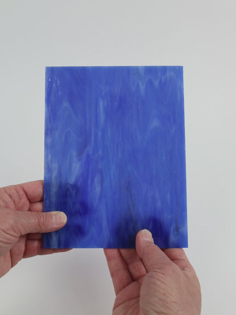 Video of the Blue Water Misty glass plate in translucent blue, 15x19cm, held up and tilted to show its pattern and transparency