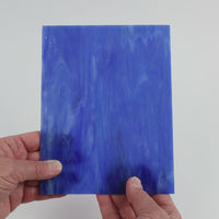 Video of the Blue Water Misty glass plate in translucent blue, 15x19cm, held up and tilted to show its pattern and transparency
