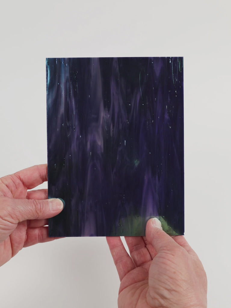 Video of the Midnight Pearl glass plate in iridescent translucent blue, 15x19cm, held up and tilted to show its pattern and transparency
