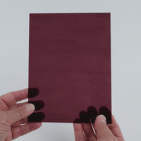 Video of the Wine Rose glass plate in transparent purple, 15x19cm, held up and tilted to show its pattern and transparency