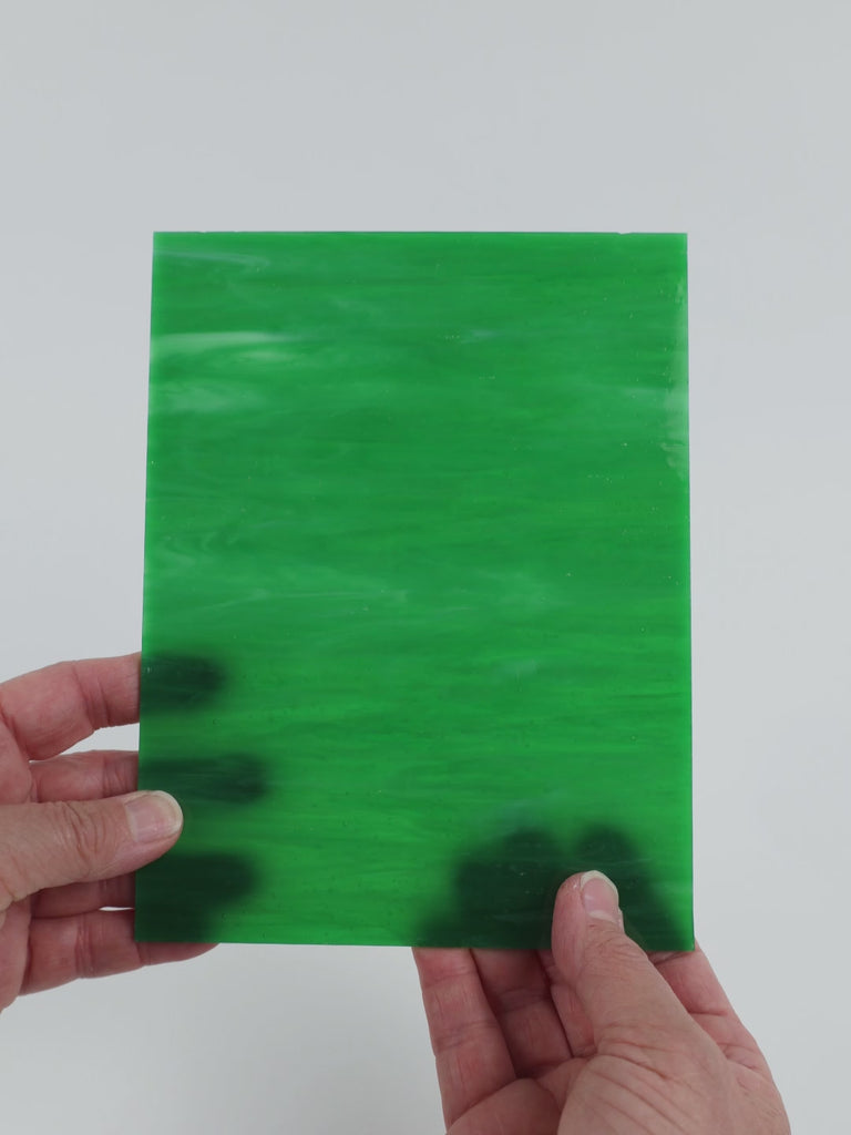 Video of the Green Opal glass plate in translucent green, 15x19cm, held up and tilted to show its pattern and transparency