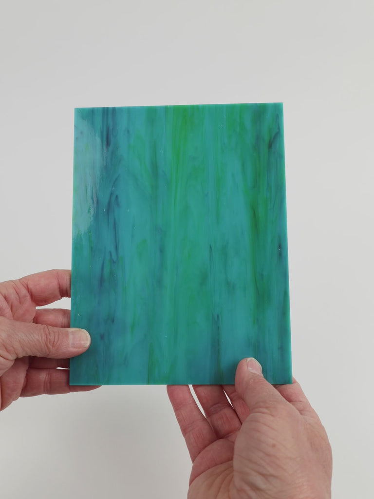 Video of the Parrotfish glass plate in translucent teal, 15x19cm, held up and tilted to show its pattern and transparency