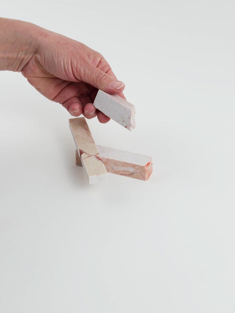 Video of Marble Bars XL Pink Cream in opaque pink natural marble, 1–20 cm long and 8 mm thick, picked up by hand and turned to show their length, colour and natural veining