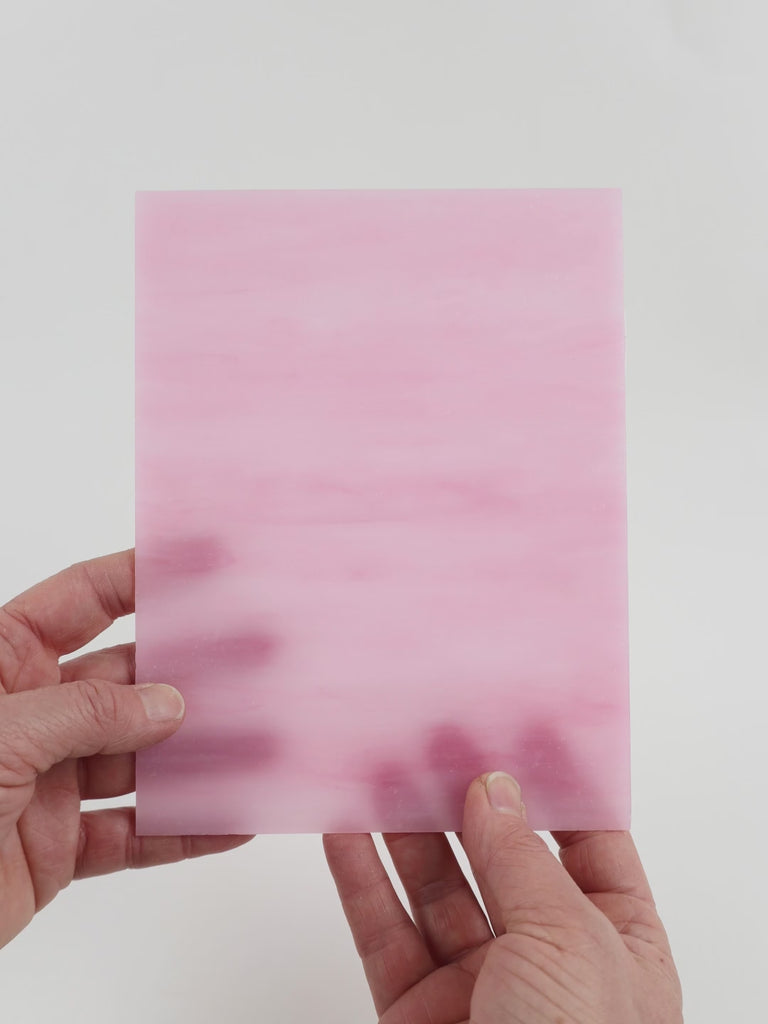 Video of the Matte Bubblegum glass plate in translucent pink, 15x19cm, held up and tilted to show its pattern and transparency