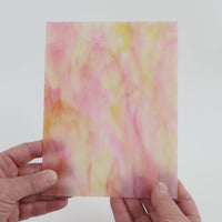 Video of the Pink Lemon Marble glass plate in translucent pink, 15x19cm, held up and tilted to show its pattern and transparency