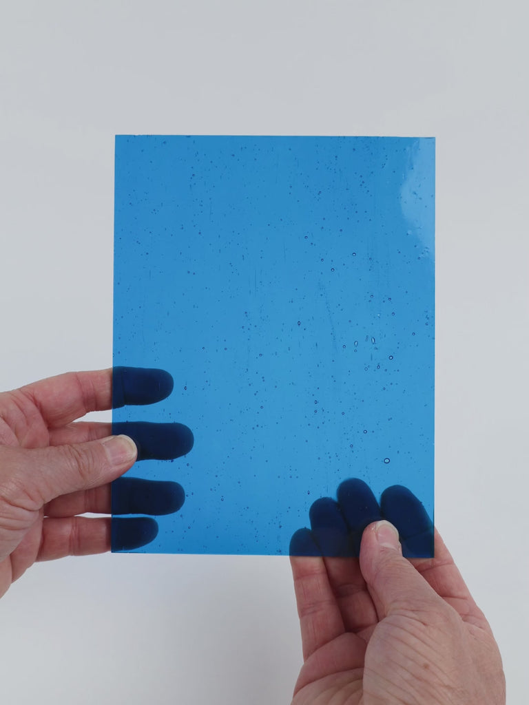 Video of the Turquoise glass plate in transparent turquoise, 15x19cm, held up and tilted to show its pattern and transparency