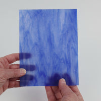 Video of the Blue Wispy glass plate in translucent blue, 15x19cm, held up and tilted to show its pattern and transparency