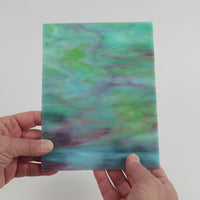 Video of the Turquoise Teal Lilac Ripple glass plate in translucent turquoise, 15x19cm, held up and tilted to show its pattern and transparency
