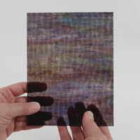 Video of the Walnut Ripple Wispy glass plate in transparant brown, 15x19cm, held up and tilted to show its pattern and transparency