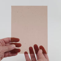 Video of the Taupe glass plate in transparent pink, 15x19cm, held up and tilted to show its pattern and transparency