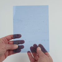 Video of the beached Blue glass plate in transparent blue, 15x19cm, held up and tilted to show its pattern and transparency