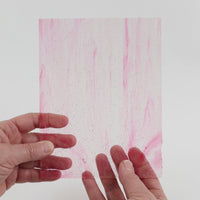 Video of the Fuchsia Wispy glass plate in transparent pink, 15x19cm, held up and tilted to show its pattern and transparency