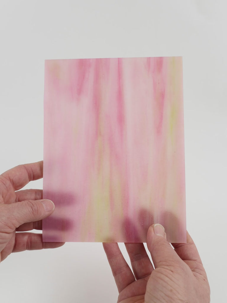 Video of the Dragon Fruit glass plate in translucent pink, 15x19cm, held up and tilted to show its pattern and transparency