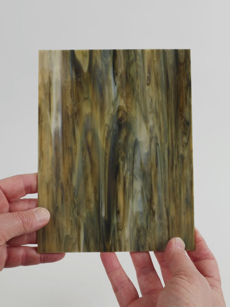 Video of the hardwood glass plate in brown translucent, 15x19cm, held up and tilted to show its pattern and transparency